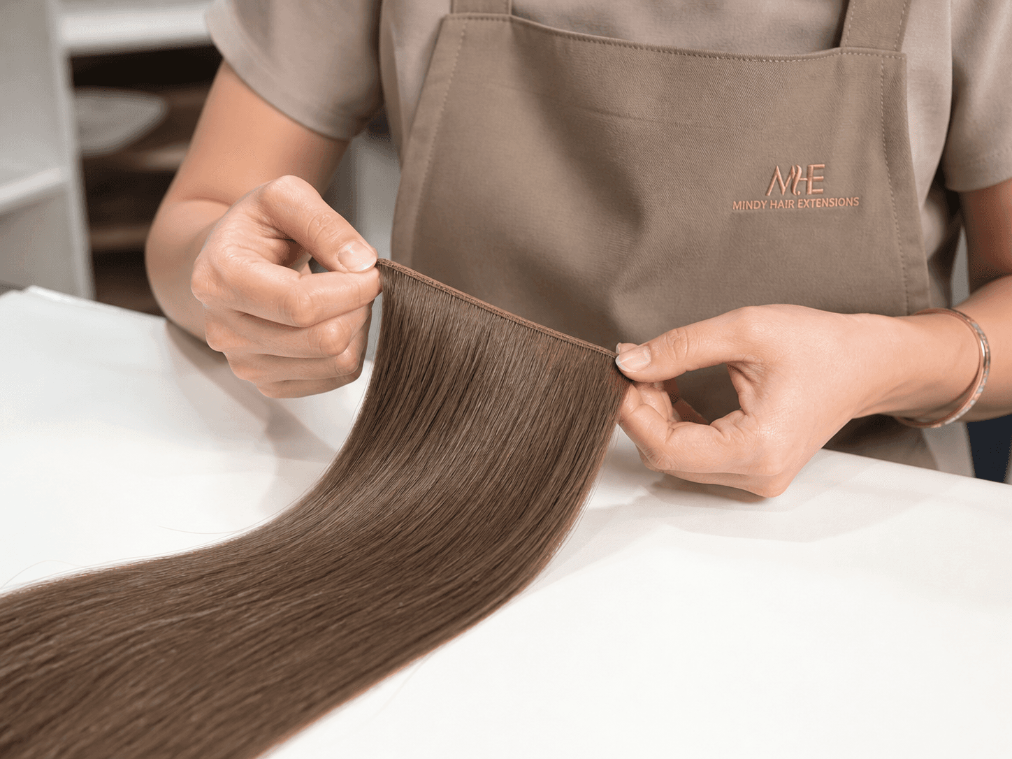 Mindy technician inspecting a Genius Weft hair extension